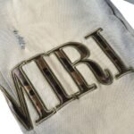 AMIRI Logo Distressed Skinny Jeans - Image 3
